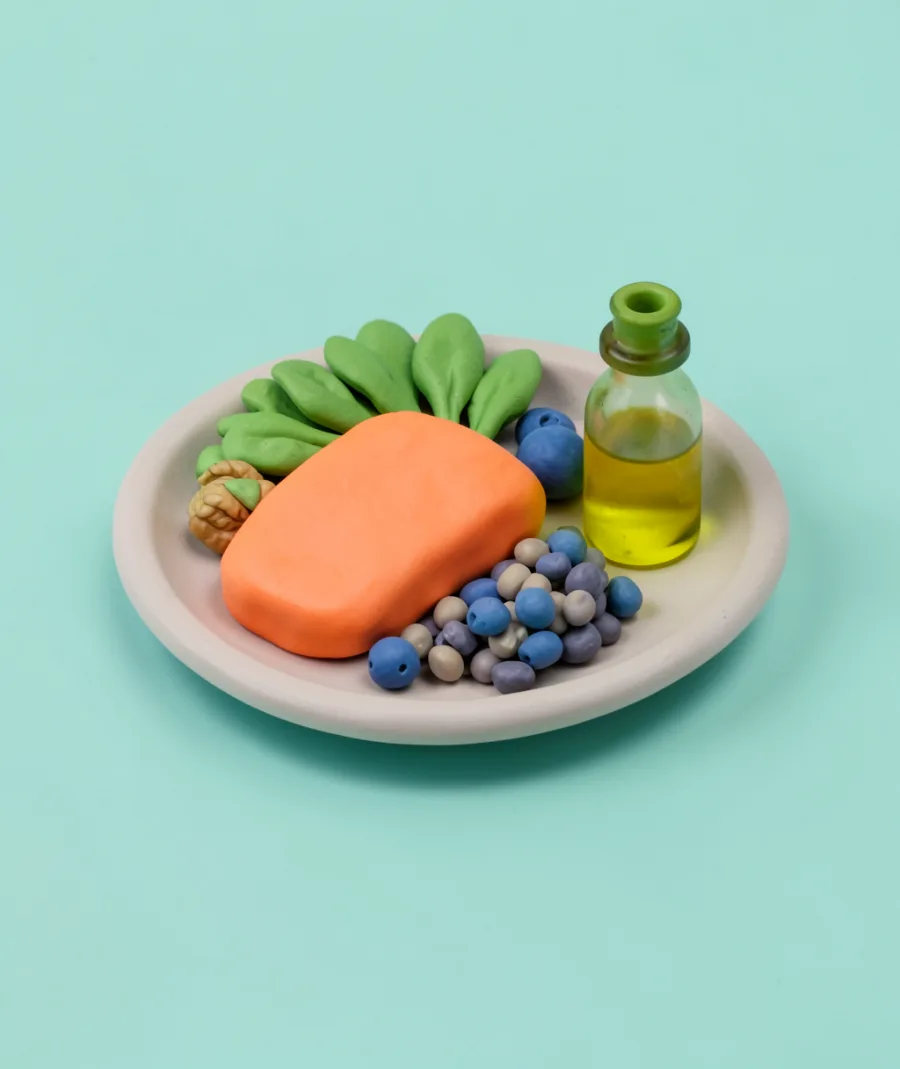 A clay plate of salmon, lentils, greens and blueberries